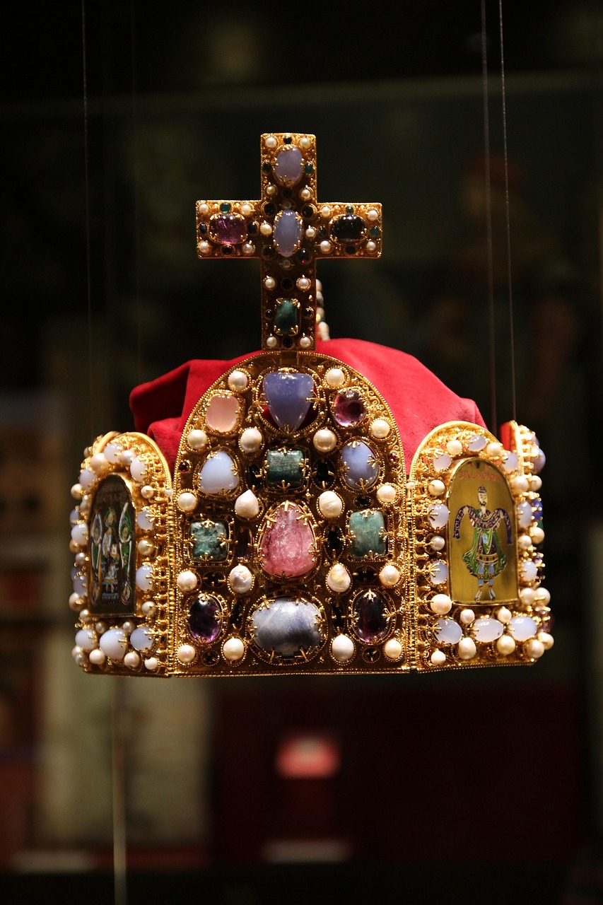 A jewelled crown suspended in darkness